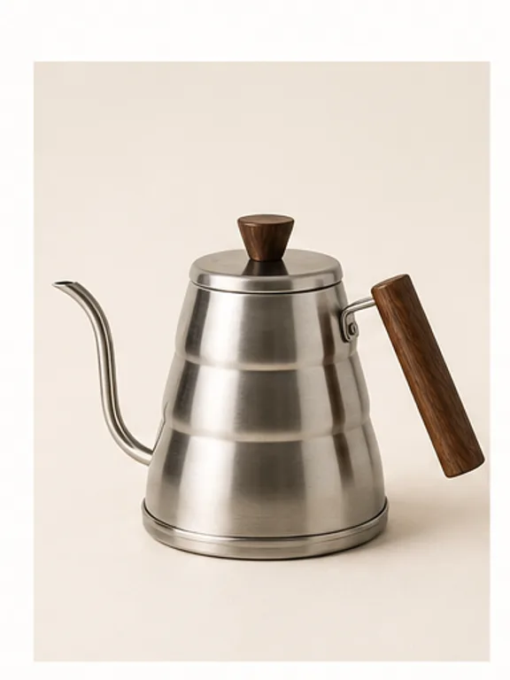 Cream gooseneck pour-over kettle beside coffee beans